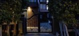 Elegant black iron gate with intricate exclusive design at dusk.