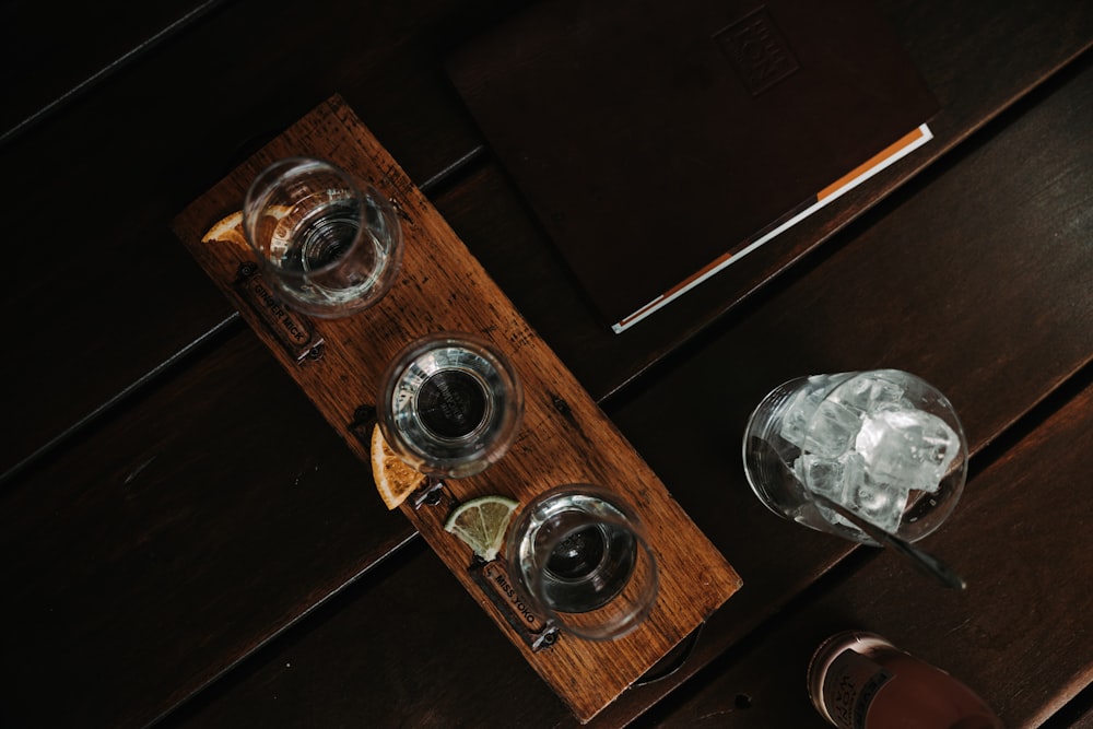 a wooden table topped with two glasses of wine