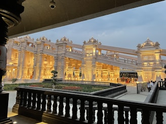 Evening view of the temple grounds with soft lighting highlighting intricate architectural details