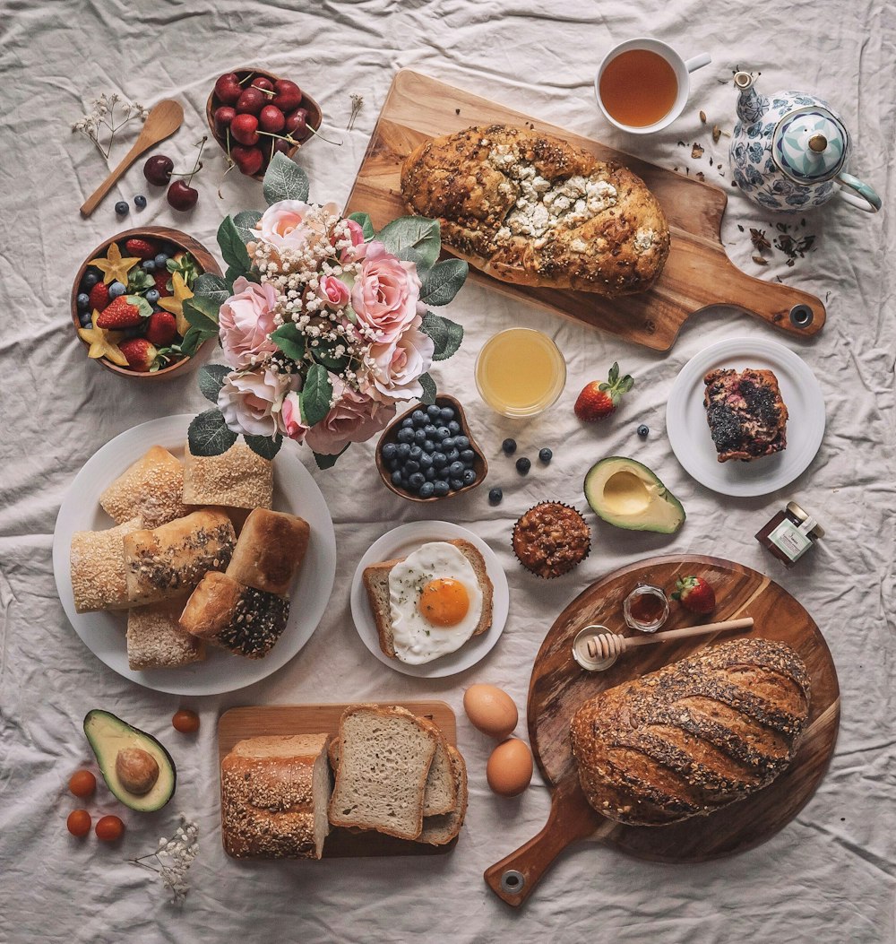 a table topped with plates of food and bread