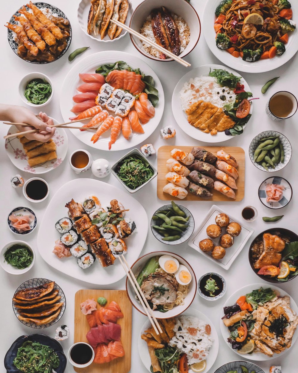 a table topped with lots of plates of food