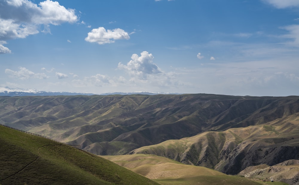 a view of a valley with mountains in the background