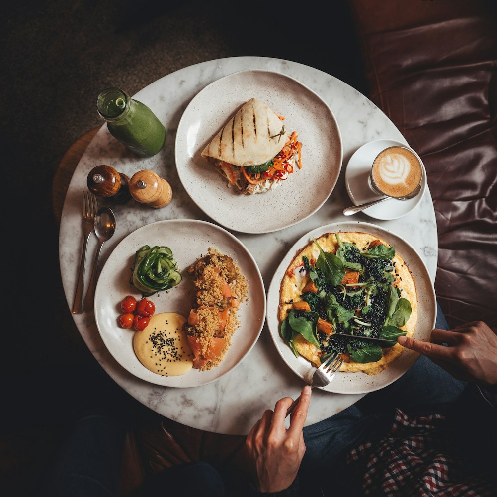 a table topped with plates of food and drinks