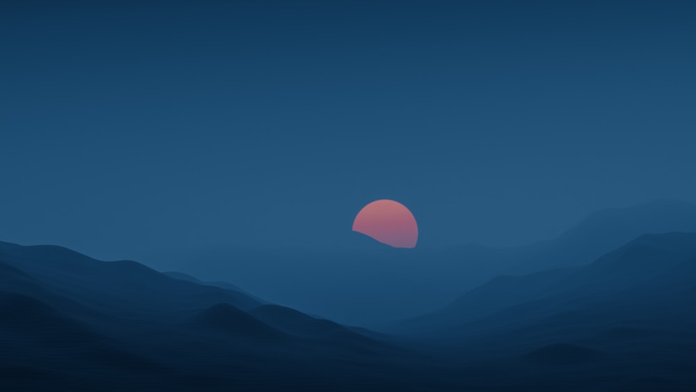 the sun is setting over a mountain range