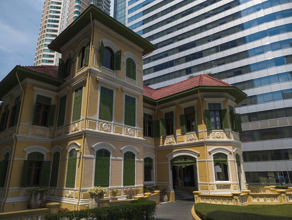 a tall building with a red roof next to a tall building