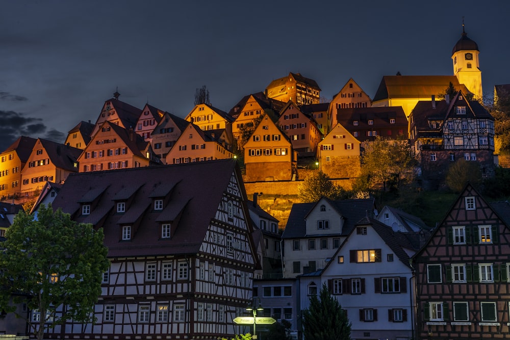 a night view of a town with a castle in the background