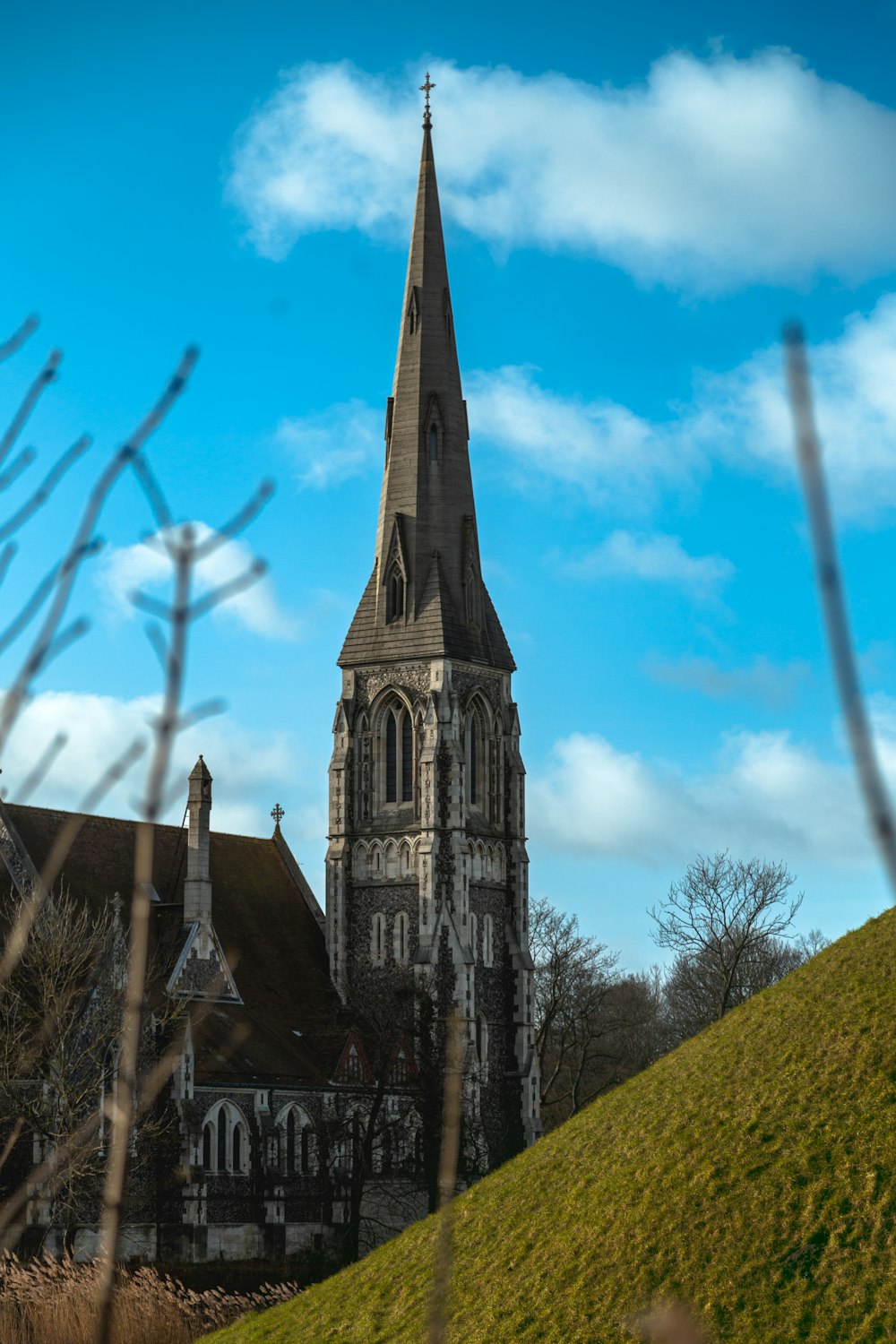 a church with a steeple on a hill