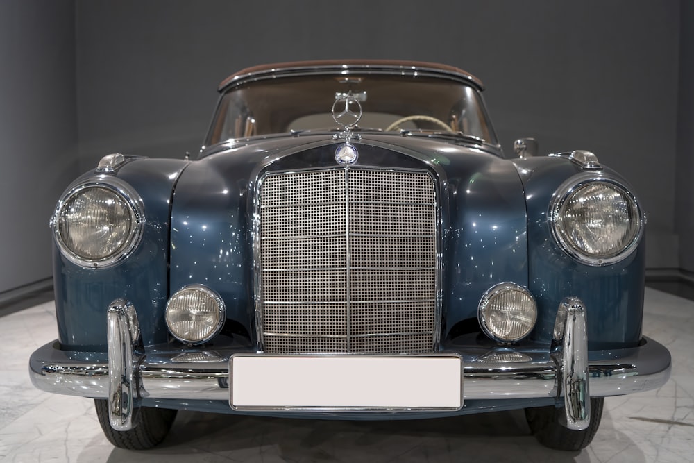 a vintage car is on display in a museum
