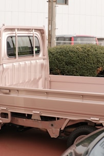 a pink truck is parked in a parking lot