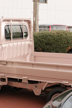 a pink truck is parked in a parking lot