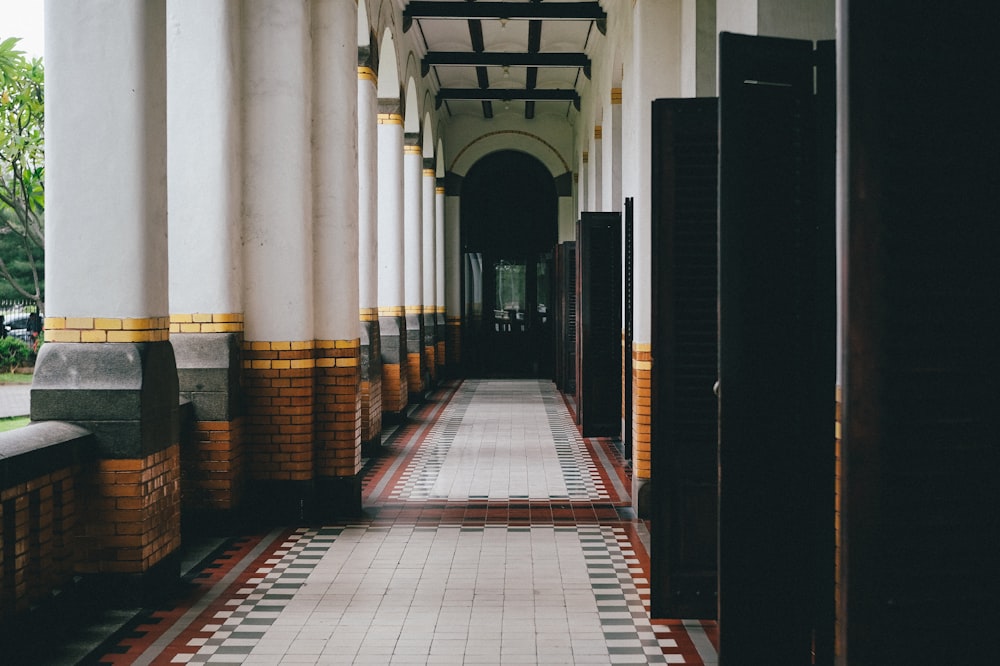 a hallway in a building with a tiled floor