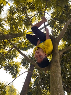 A nostalgic childhood snapshot showing young Martins playing joyfully under the shade of a large tree.