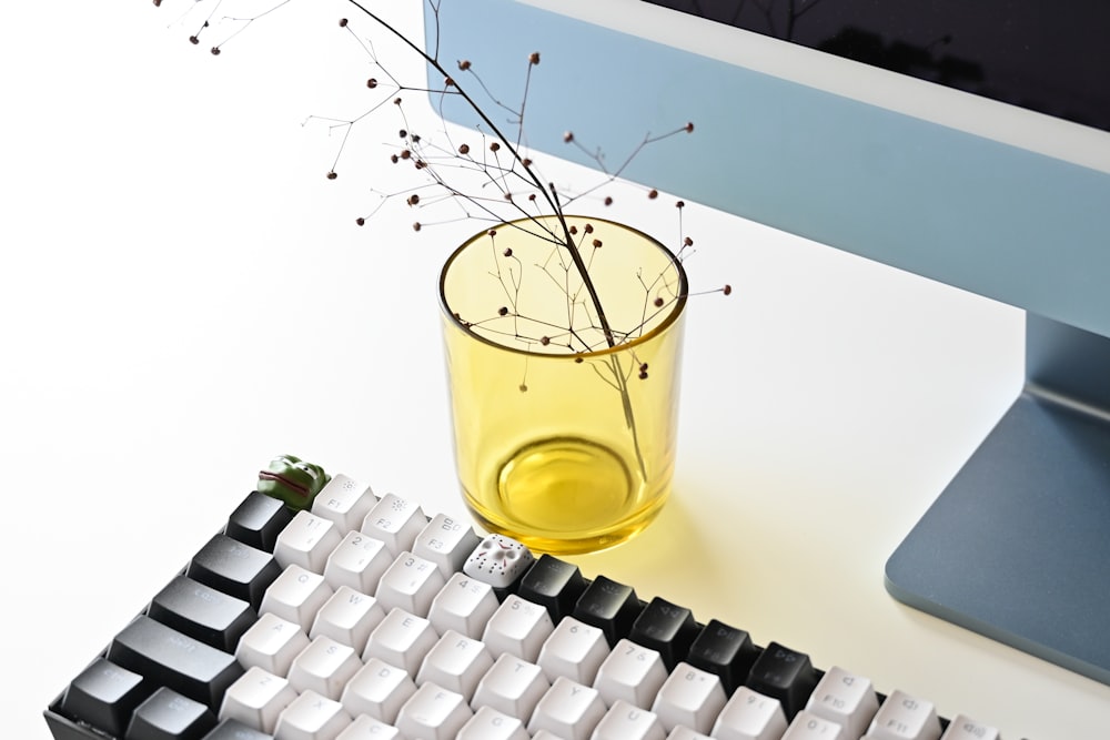 a glass of water sitting next to a computer keyboard
