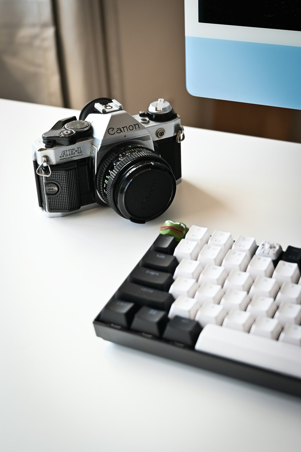 a camera and keyboard sitting on a desk