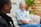 A friendly insurance advisor discussing options with a young couple in a cozy setting.