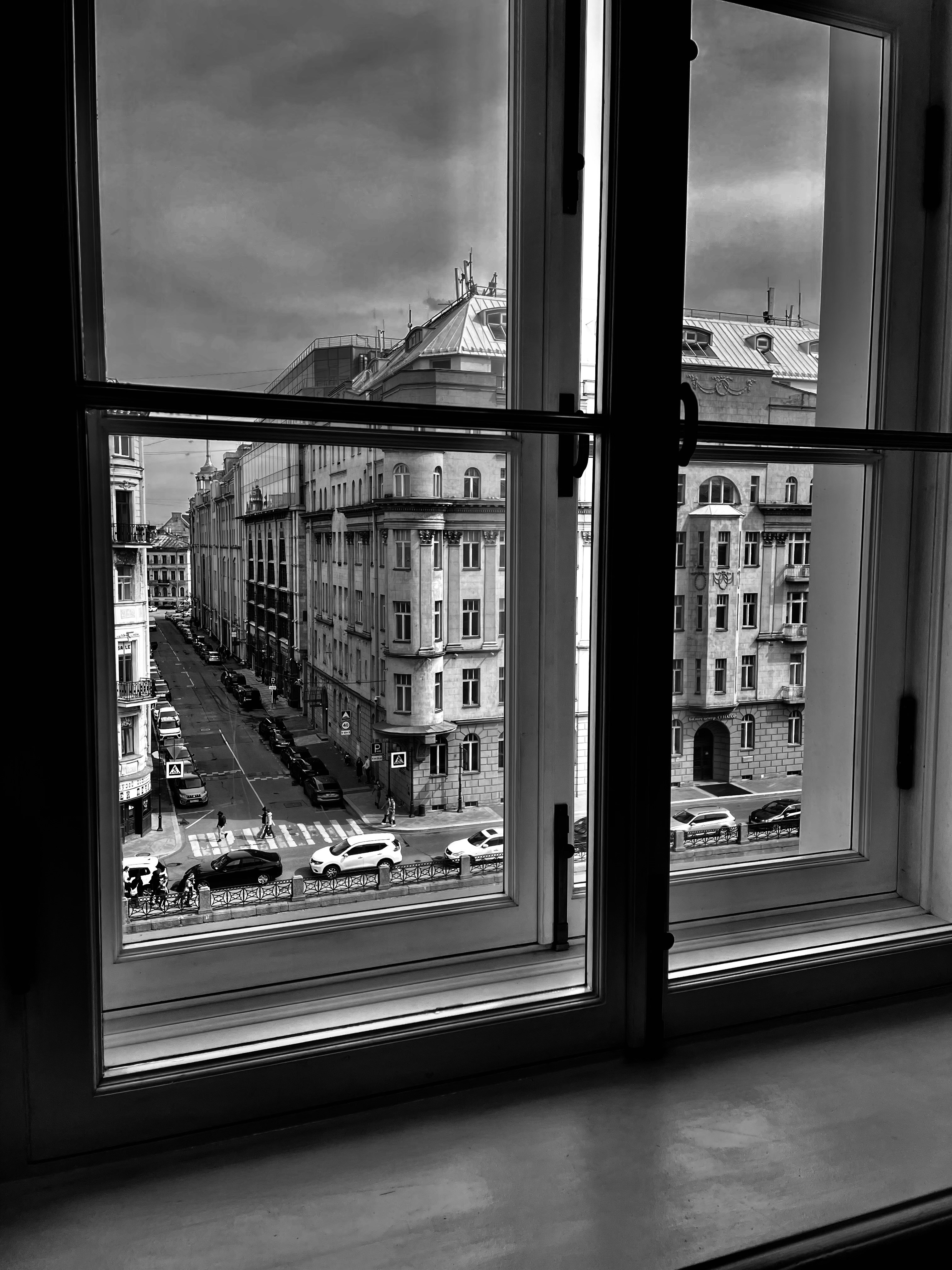 a black and white photo of a city from a window