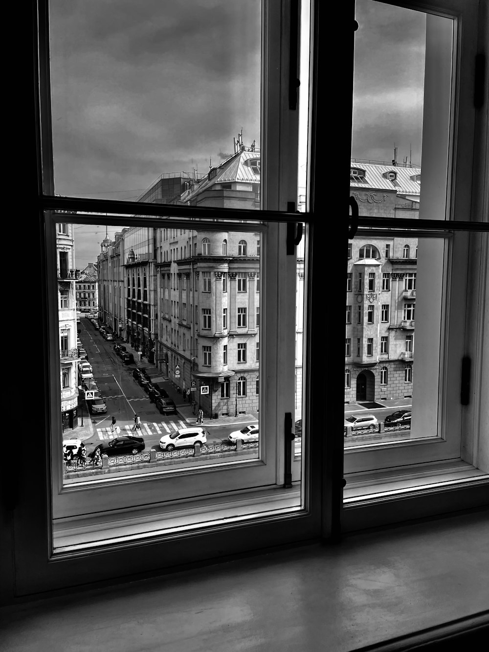 a black and white photo of a city from a window