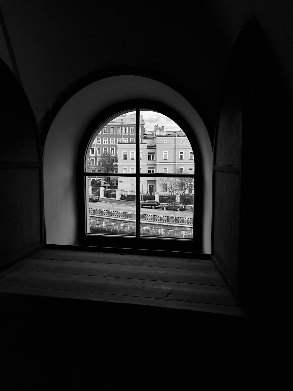 a black and white photo of a window in a building