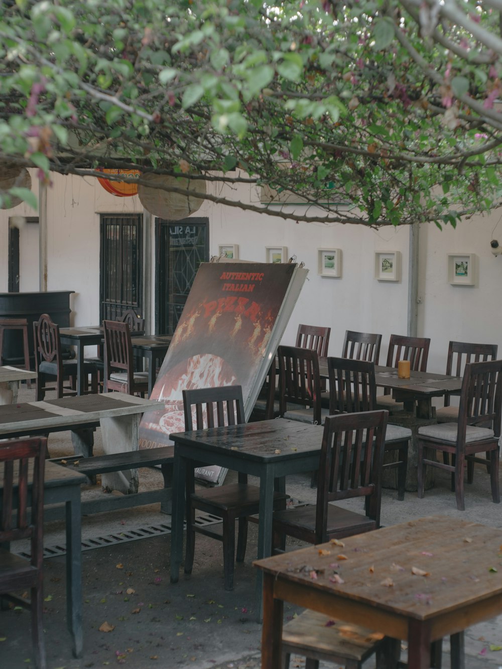 a restaurant with tables and chairs under a tree