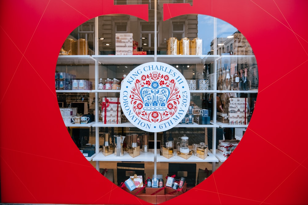 a red apple shaped window with a logo on it