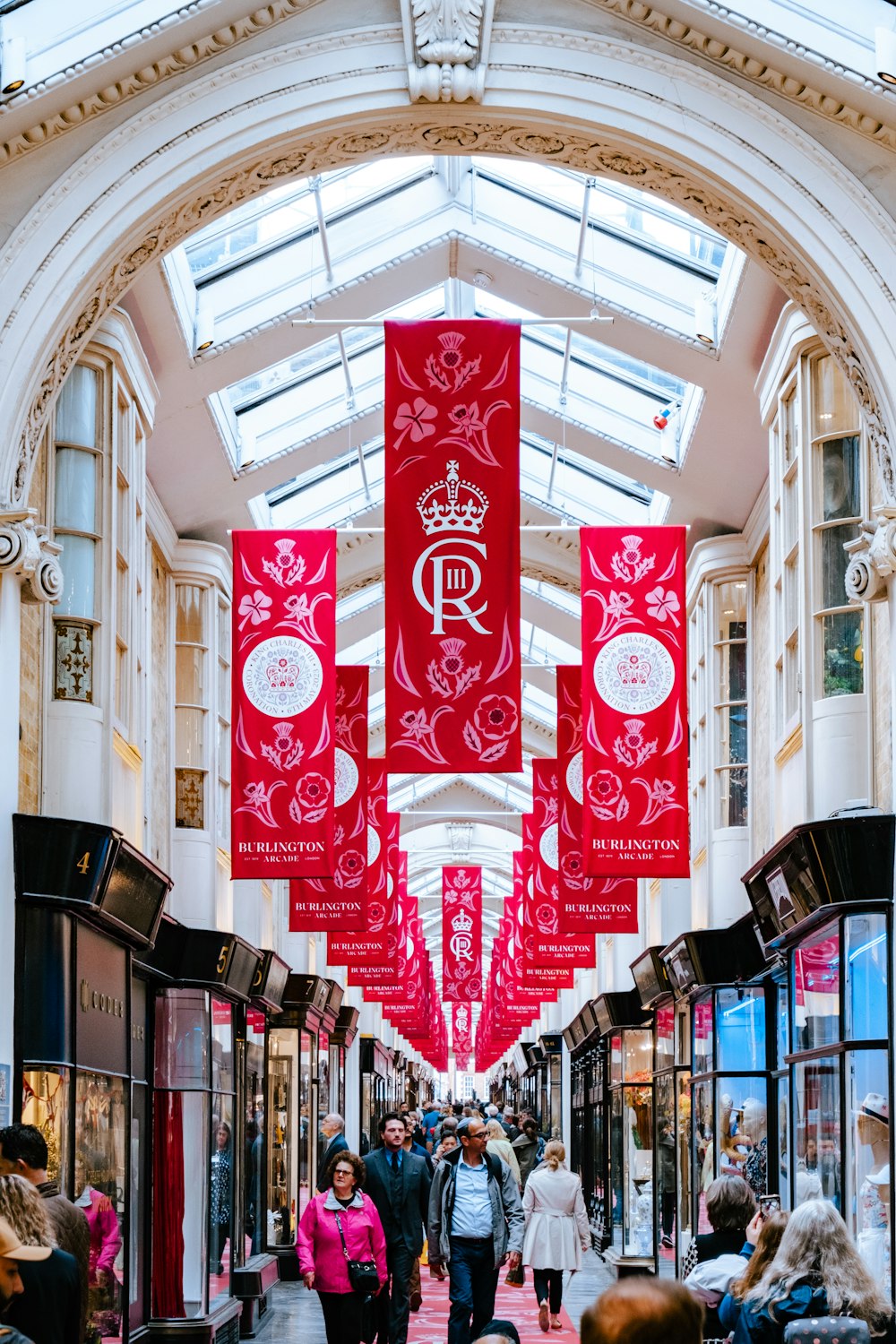 a group of people walking through a shopping mall