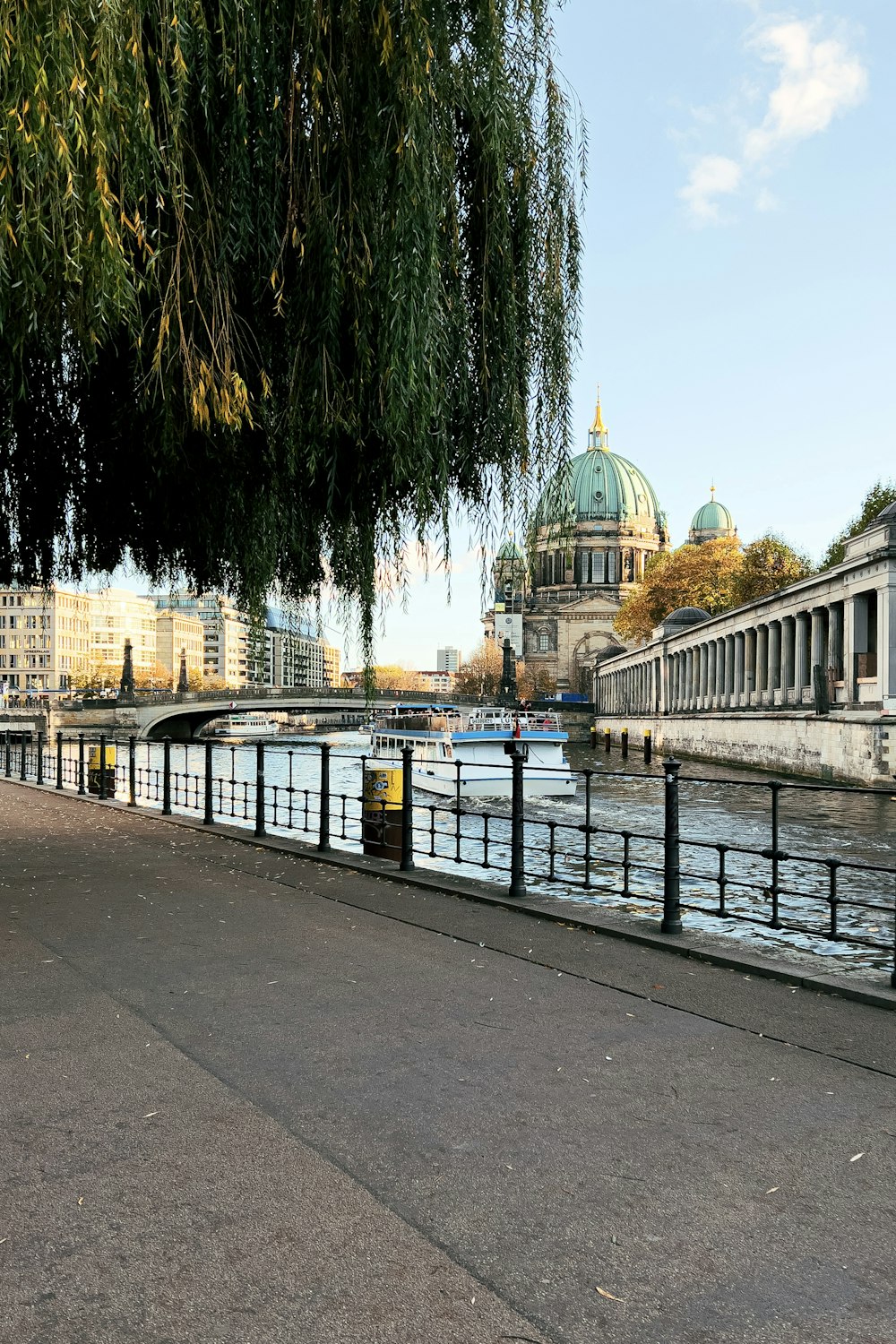 a view of a river with a bridge in the background