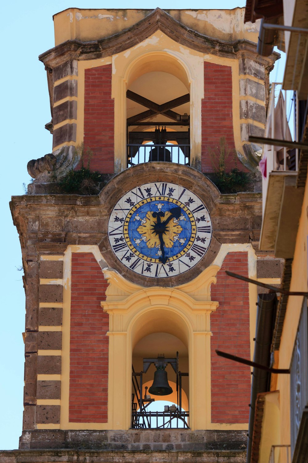 a clock tower with a bell on top of it