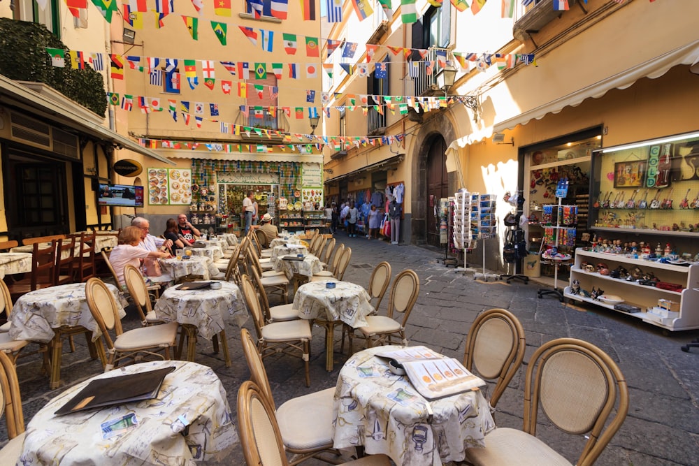 a group of people sitting at tables in a restaurant