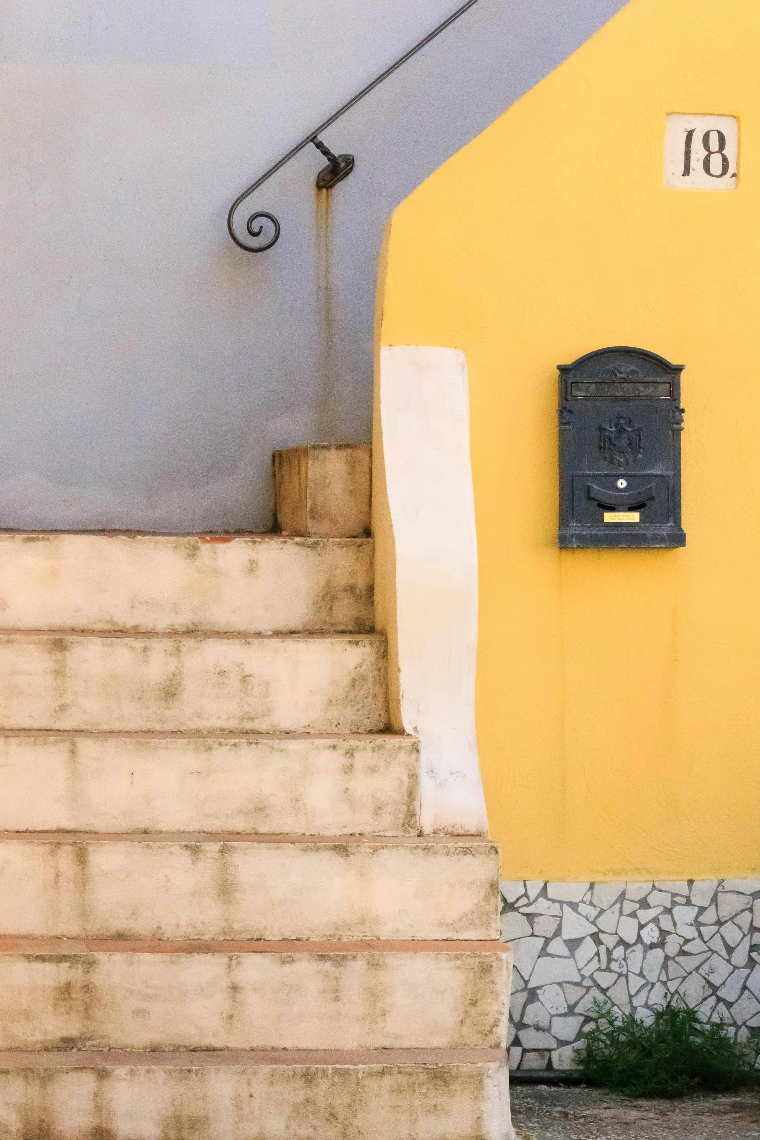 a cat sitting on the steps of a building