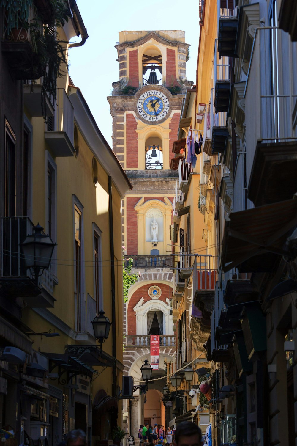 a clock tower towering over a city street