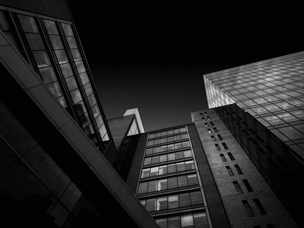 a black and white photo of tall buildings