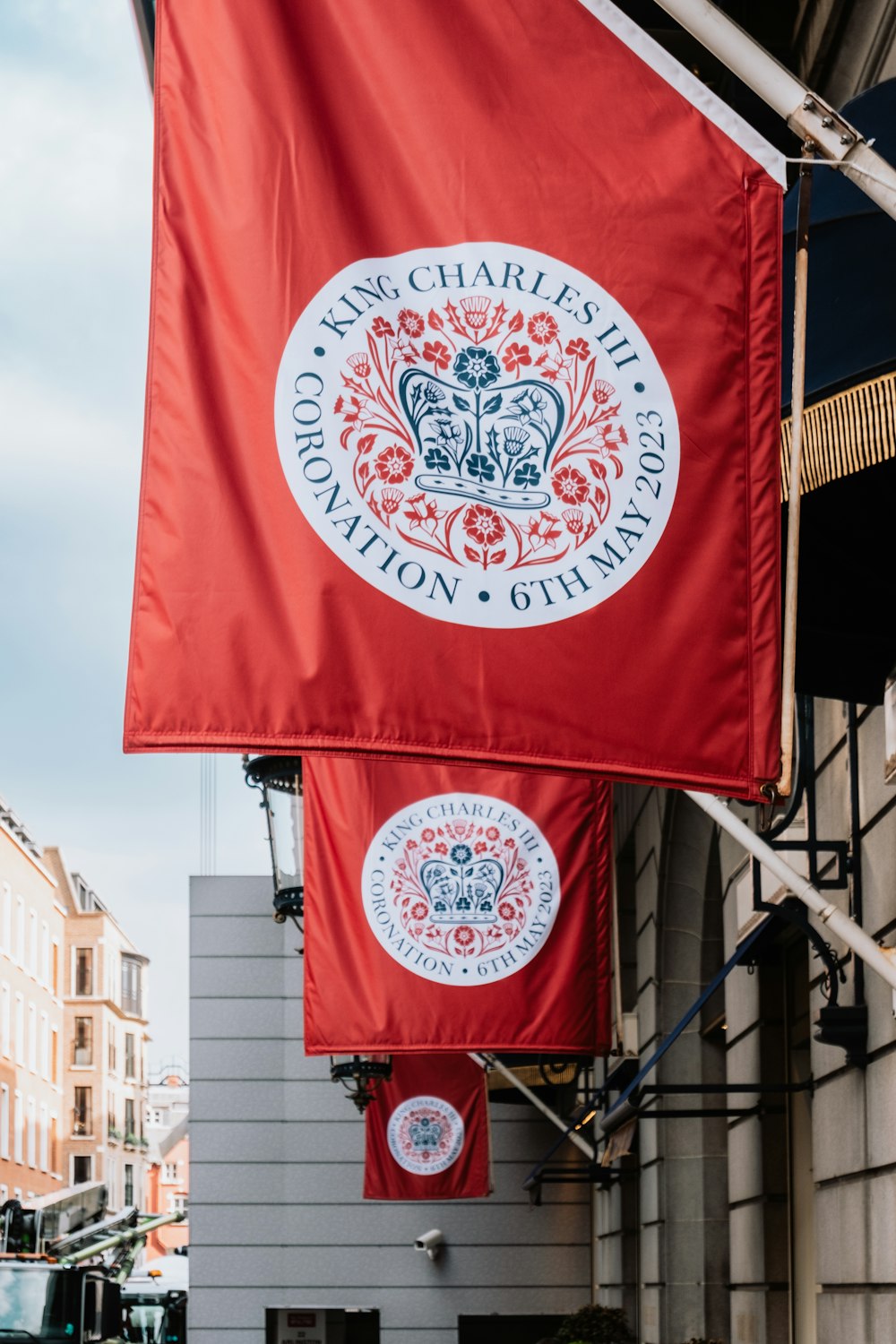 a red flag hanging from the side of a building