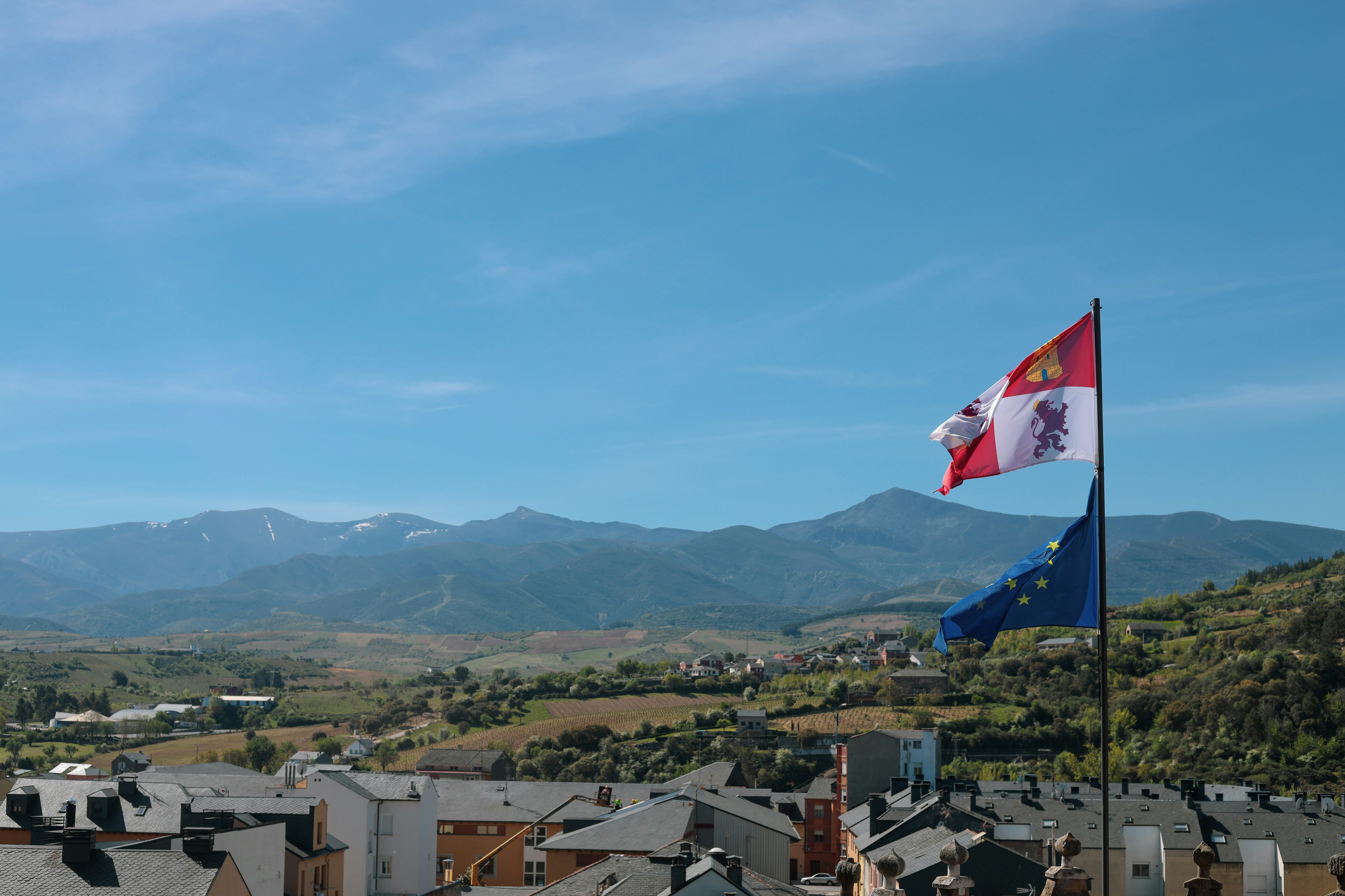 a flag flying on top of a building next to a mountain
