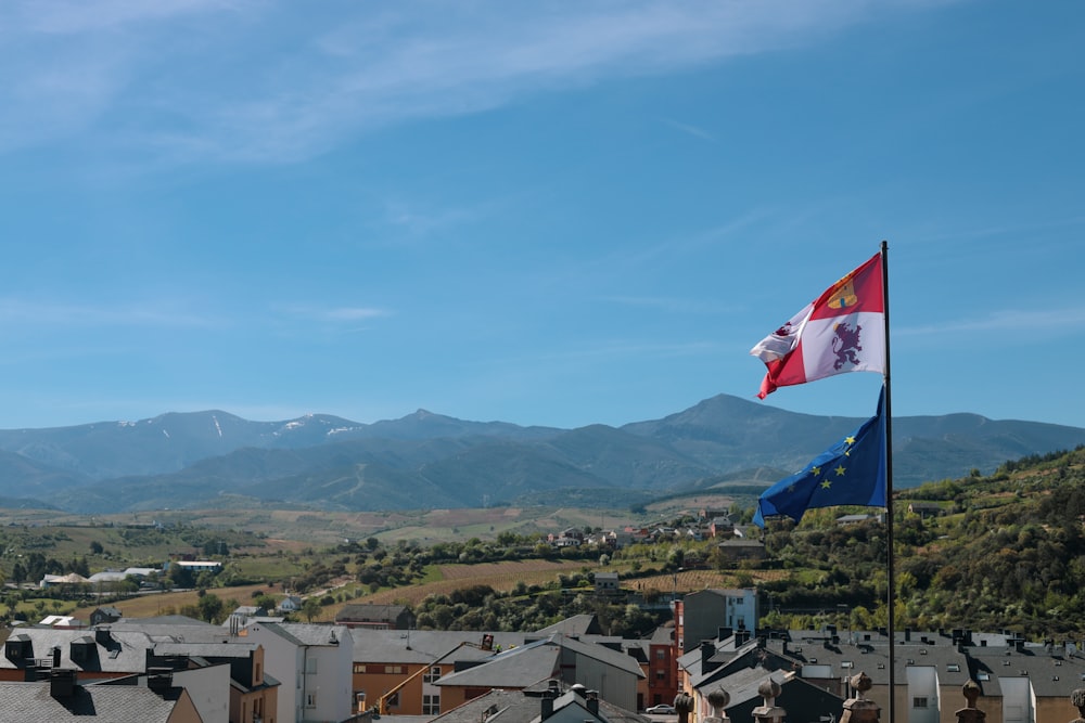 a flag flying on top of a building next to a mountain