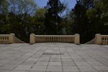 Wide shot of a spacious terrace featuring large-format ceramic tiles with mineral grey tones under natural mountain light.