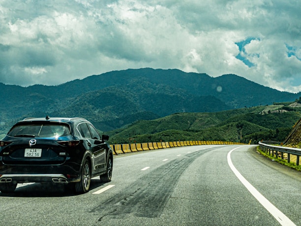 A happy family enjoying a scenic drive in a luxury SUV on a sunny day.