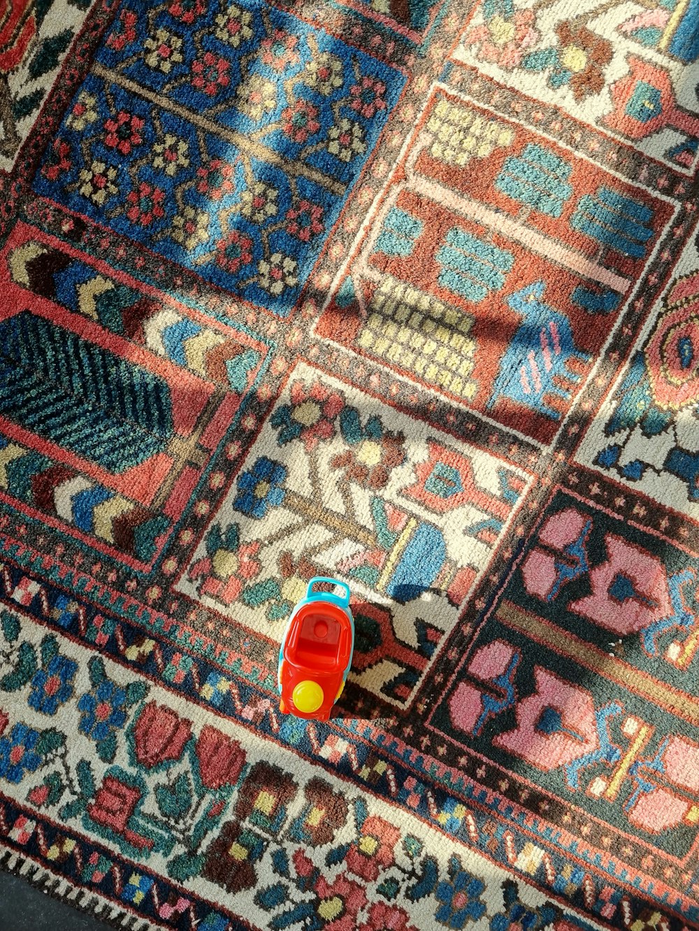a colorful rug with a toy on top of it