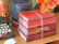 A stack of romance novels tied with a delicate ribbon on a wooden table.