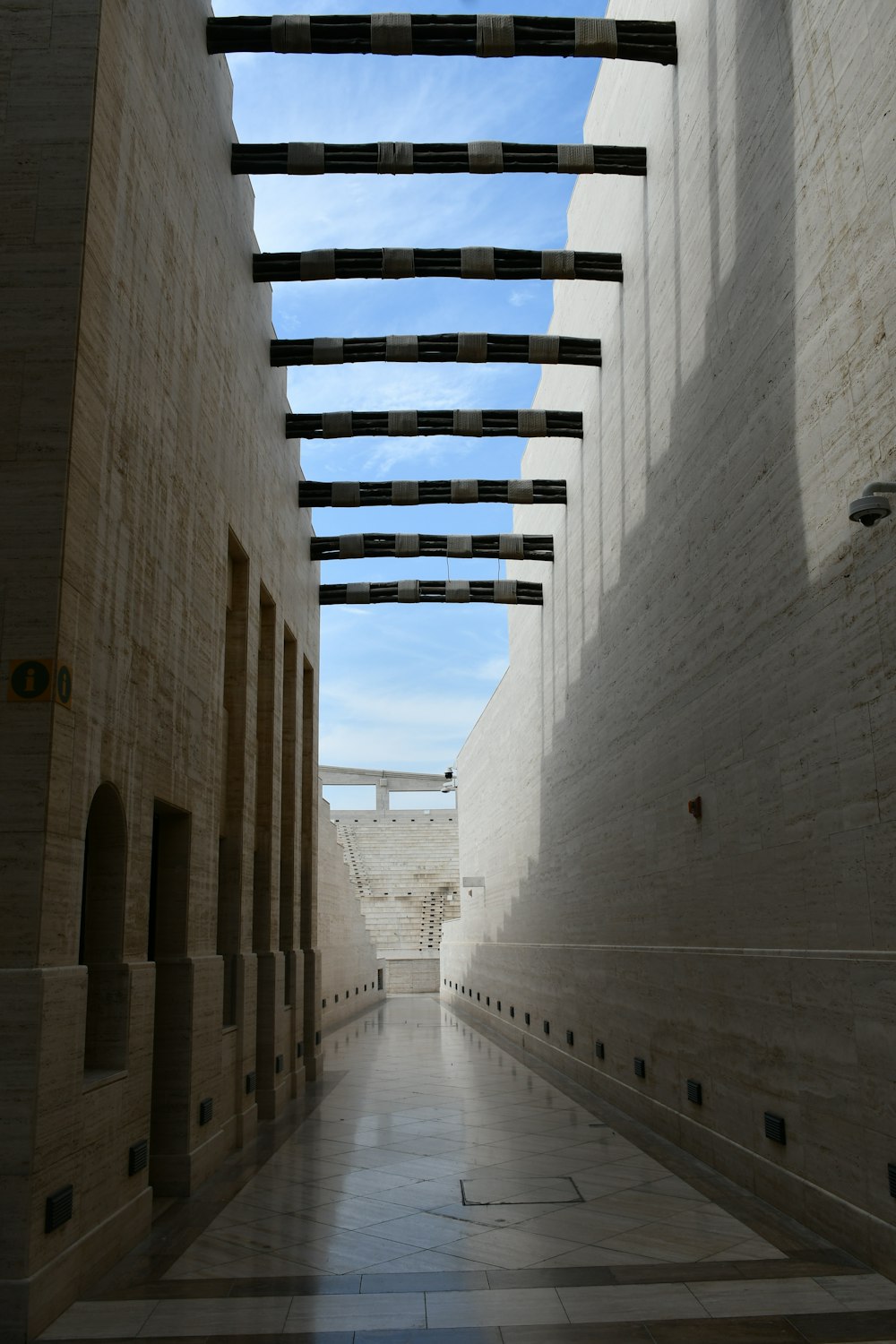 a long narrow hallway with a sky background