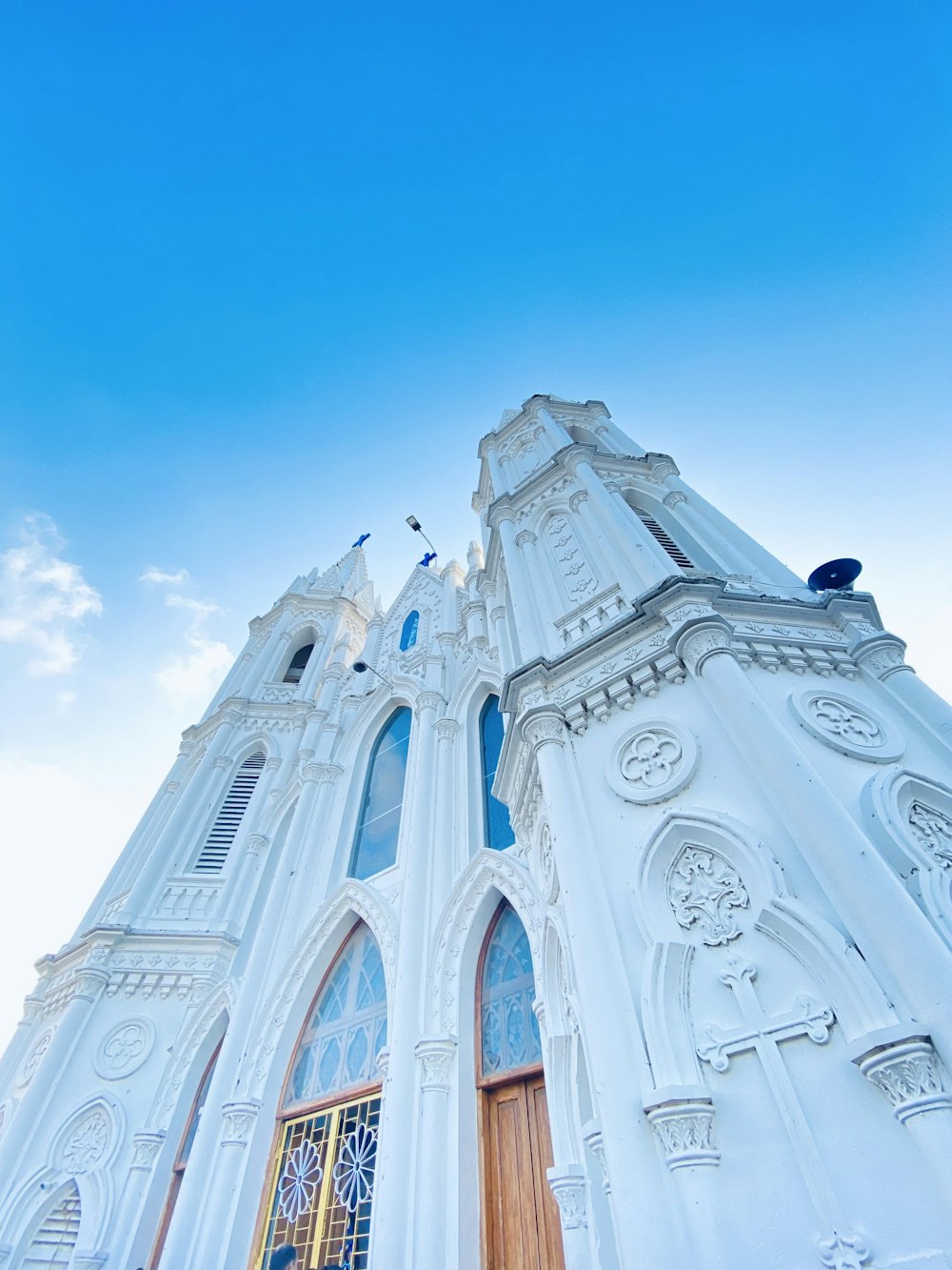 a tall white church with a sky background