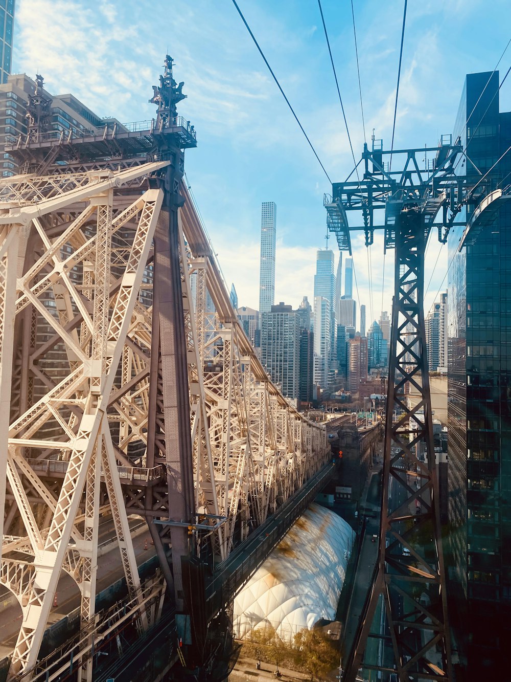 a train traveling over a bridge next to tall buildings