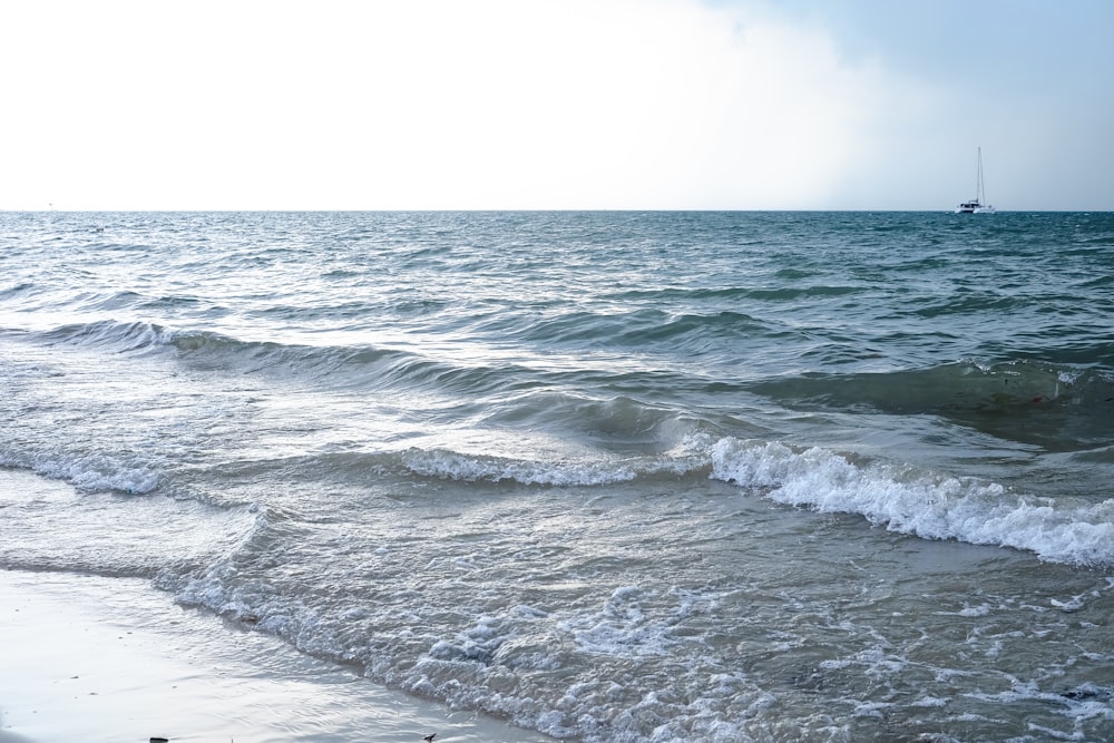 a boat is out in the ocean on a sunny day