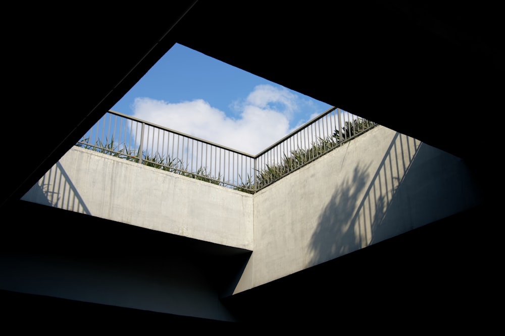 a view of a balcony from underneath a building