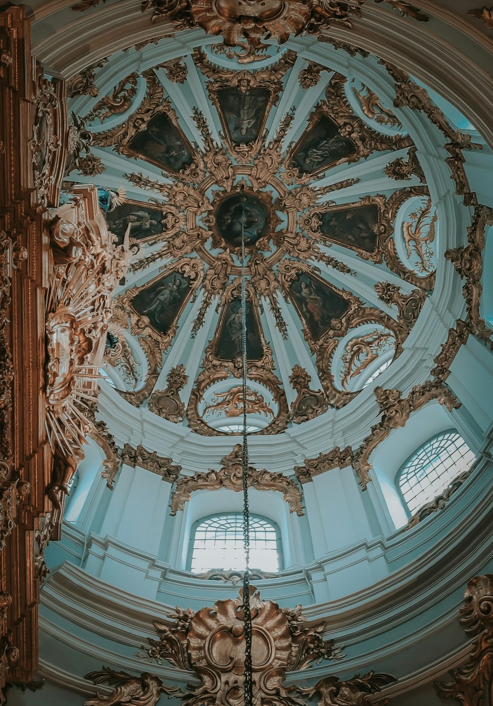 the ceiling of a large building with a clock on it