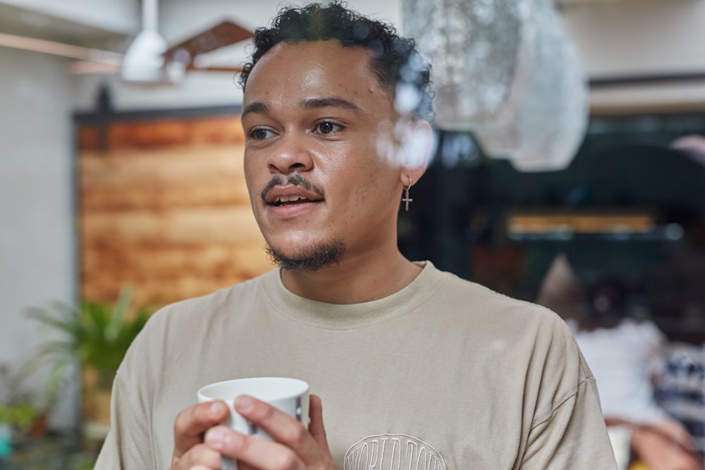 a man holding a coffee cup in his hands