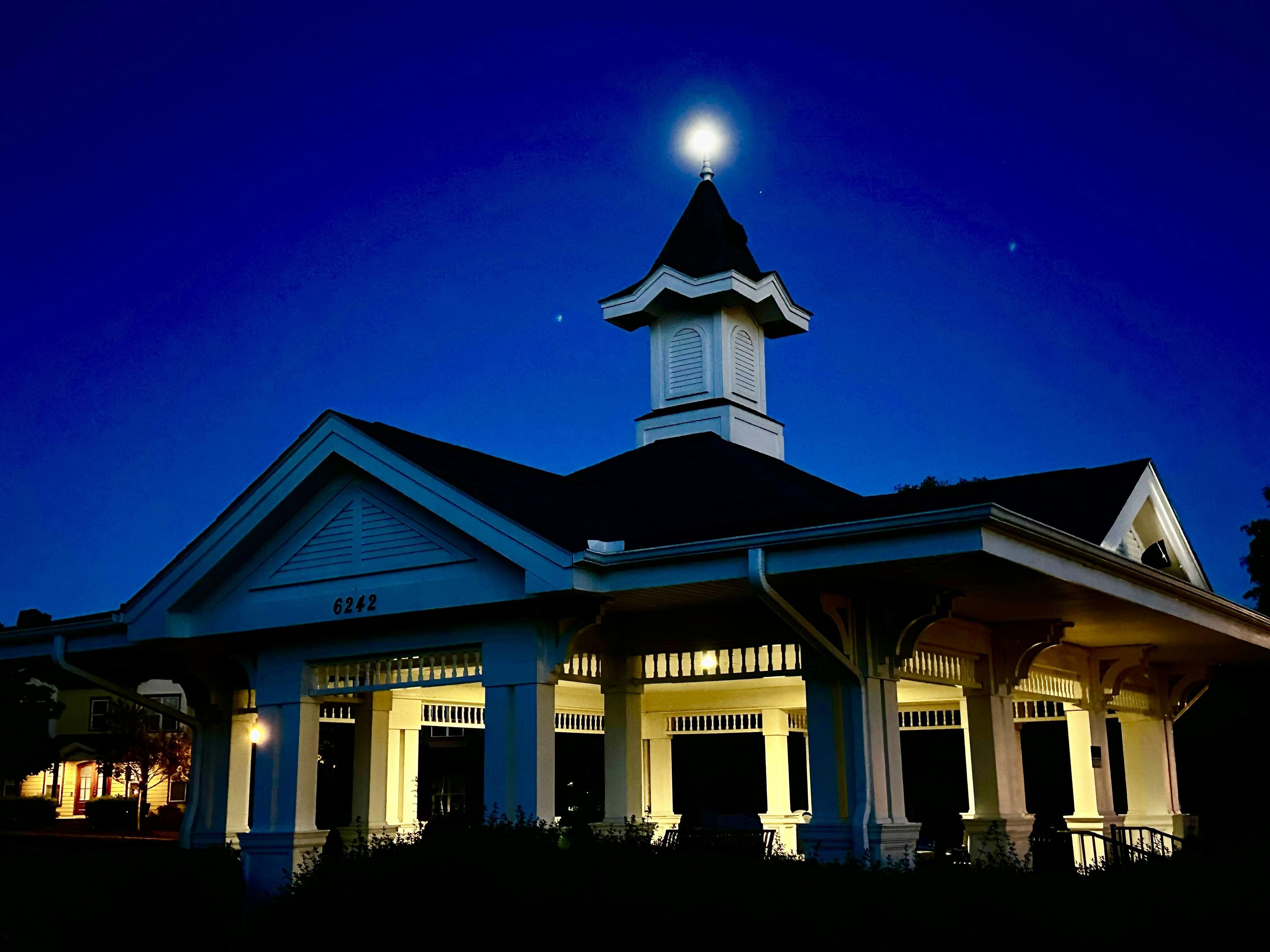 a white building with a clock tower at night
