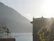 A smiling guest enjoying the serene lake view from the cozy porch of Hisar Guest House.