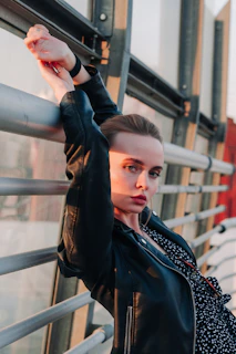 Sleek black jacket displayed against a sunlit urban rooftop backdrop at golden hour