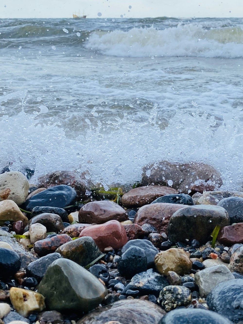 a bunch of rocks sitting on top of a beach