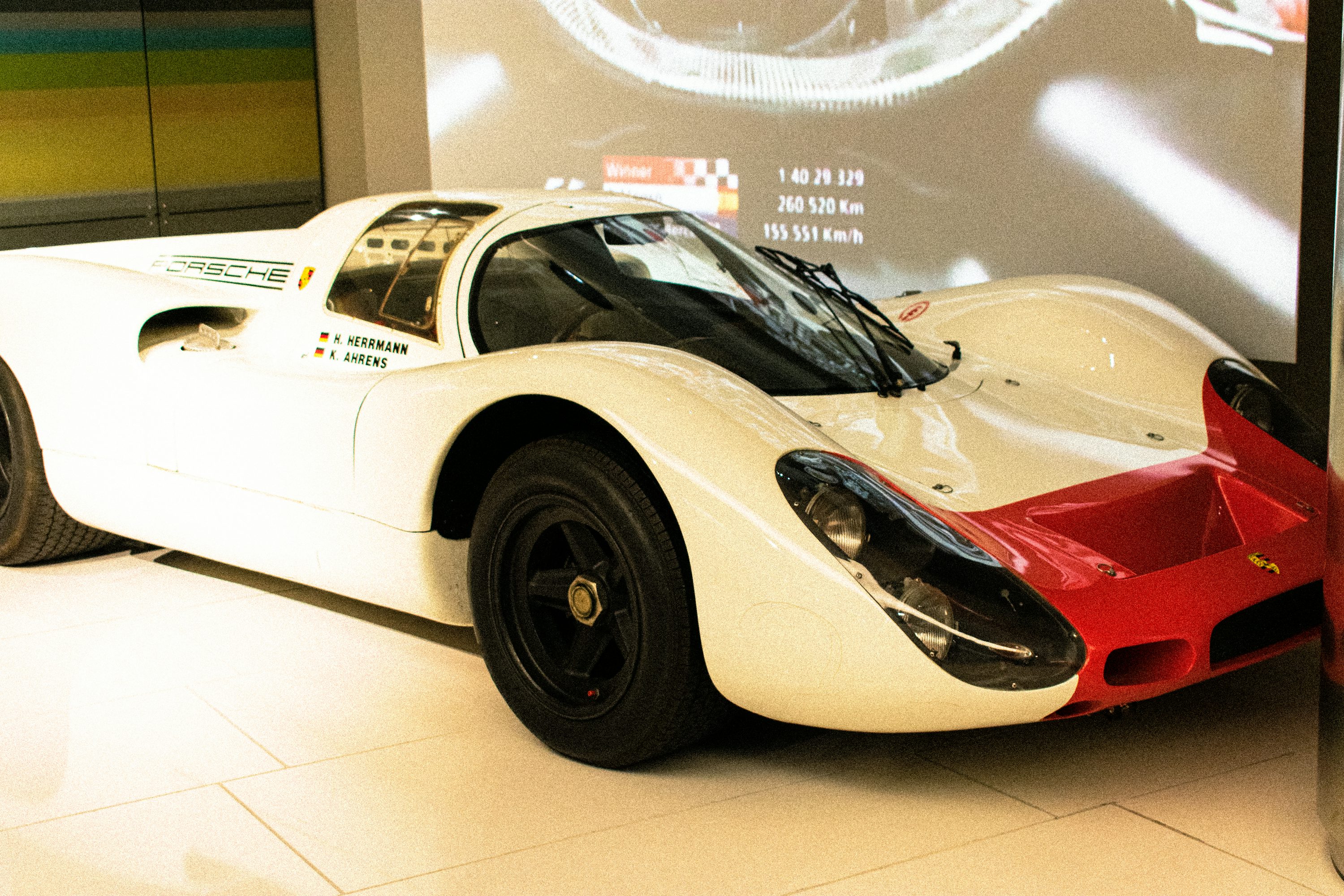 a white and red race car on display in a museum